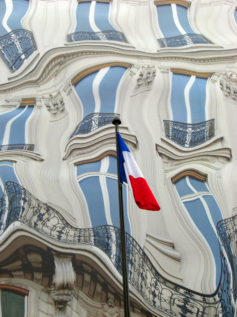 Perception is not reality Distorted picture of a building, with undistorted flag