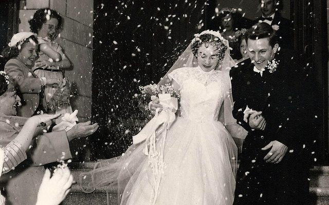 A young couple is showered with confetti at their wedding